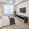large, carpeted bedroom with ample lighting