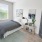 large window brightens spacious bedroom