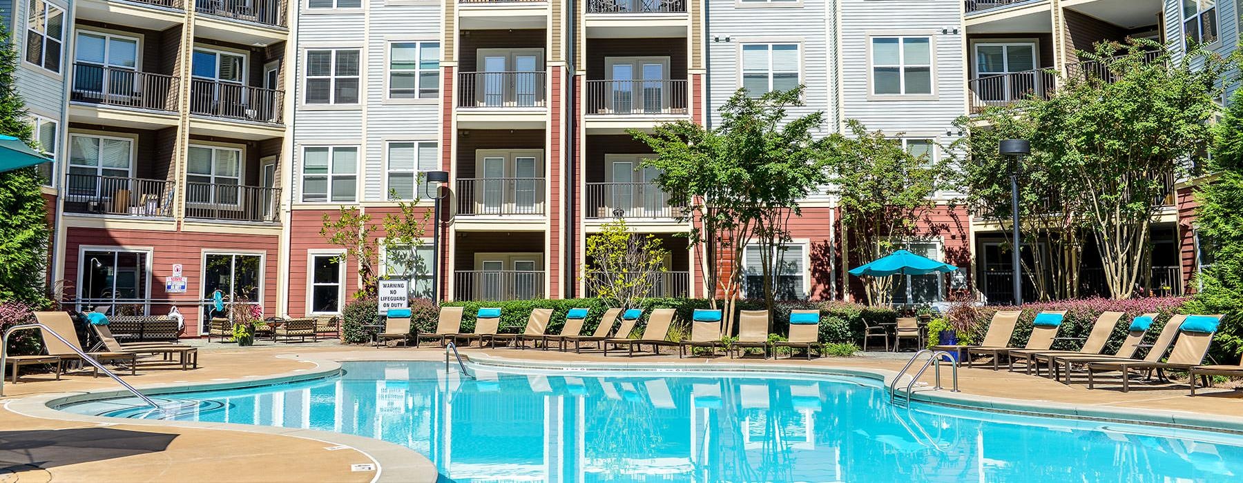 lounge chairs surround swimming pool